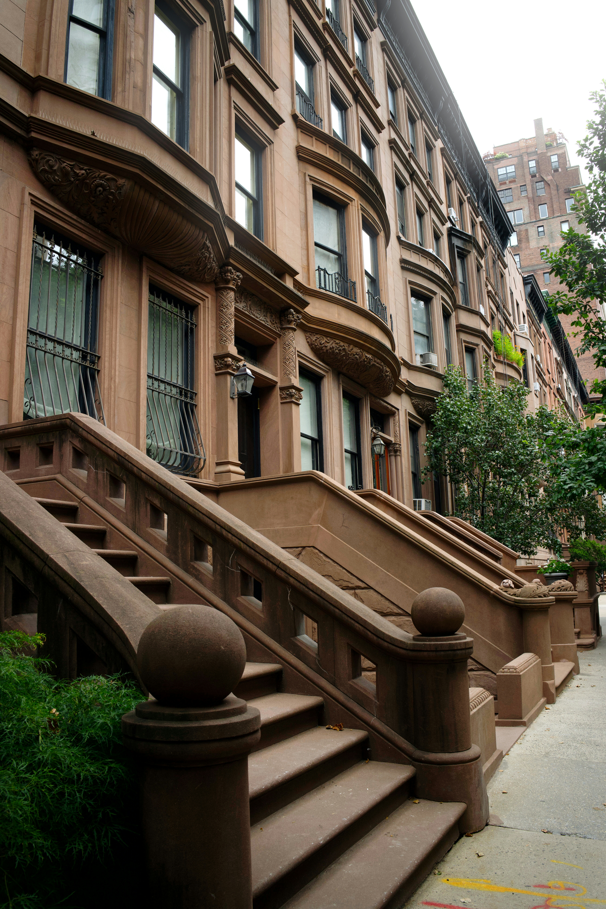 Brownstone row houses with stone stoops